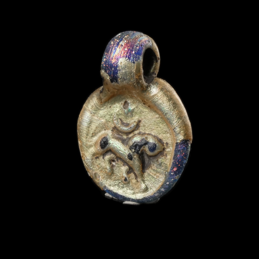 Late Roman glass amulet pendant with Lion, Moon and Sun/Star