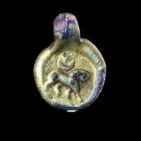 Late Roman glass amulet pendant with Lion, Moon and Sun/Star